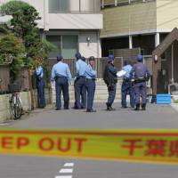 Police investigate the area in Matsudo, Chiba Prefecture, last month where three officers fired 13 shots at a violent dog. | KYODO
