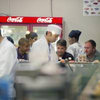 U.S. personnel dine at a sushi bar in Chatan, Okinawa Prefecture. | ARI HATSUZAWA