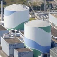 Kyushu Electric Power Co. plans to restart the No. 2 reactor (right) at its Sendai nuclear power plant. | KYODO