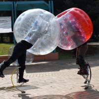 Two players duke it out in Bubble Jumper, one of six \"superhuman\" sports on show at Tokyo\'s National Museum of Emerging Science and Innovation on Thursday. | SATOKO KAWASAKI