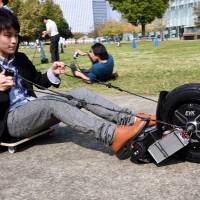 In a \"superhuman\" game called Chariot, players race each other while pulled by self-propelled wheel. | SATOKO KAWASAKI