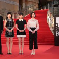 Hello Hollywood: Film director Taketoshi Sado and the members of Perfume (Kashiyuka, A-chan and Nocchi) pose on the red carpet at the Tokyo International Film Festival. | BLOOMBERG