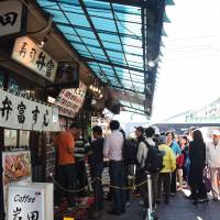 Customers line up outside a sushi restaurant at Tsukiji fish market on Oct. 15.  | SATOKO KAWASAKI