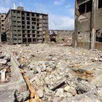 Industrial wasteland: All that is left on Gunkanjima are abandoned buildings, rubble and memories of an overcrowded bustling mining community. | TIM HORNYAK