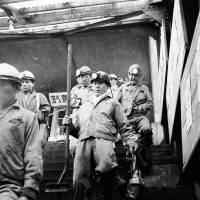 Miners express relief as they exit the Hashima Island underground mine tunnels and descend the Nyuko Sanbashi entrance stairs. | ARCHIVAL PHOTOGRAPHS USAGE AND PUBLICATION WITH PERMISSION FROM ROMAN CATHOLIC ARCHDIOCESE OF NAGASAKI