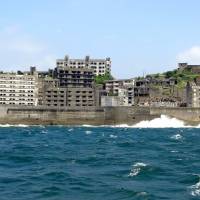 Now called Gunkanjima, Hashima Island appears ominous as tour ferries approach. | TIM HORNYAK