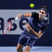 Roger Federer hits a returns to David Goffin during their quarterfinal match at the Swiss Indoors tournament on Friday in Basel, Switzerland. Federer won 6-3, 3-6, 6-1. | AFP-JIJI