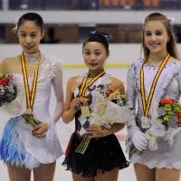 Yuna Shiraiwa (center) poses with her gold medal alongside Yura Matsuda (left) and Russia\'s Alisa Fedichkina after winning the Junior Grand Prix in Logrono, Spain, on Friday night. | FACEBOOK / ISU