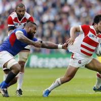 Shota Horie (right) takes Samoa\'s Faifili Levave for a ride during the two teams\' Rubgy World Cup match on Saturday. | REUTERS