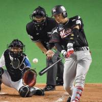 The Marines\' Toshiaki Imae hits a bases-clearing double in the second inning against the Fighters in Game 1 of the Pacific League Climax Series final stage on Saturday at Sapporo Dome. Chiba Lotte beat Hokkaido Nippon Ham 9-3. | KYODO