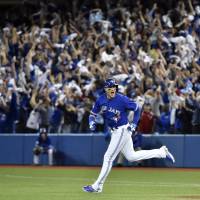 Toronto’s Troy Tulowitzki rounds the bases after hitting a three-run homer against Kansas City in Game 3 of the ALCS on Monday. The Blue Jays beat the Royals 11-8 and trail 2-1 in the series. Blue Jays blast Royals