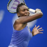 Venus Williams hits a return against Roberta Vinci in the Wuhan Open semifinals on Friday. | AFP-JIJI