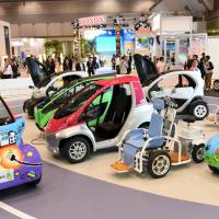 A visitor takes a spin in one-person vehicle in a corner of the Tokyo Motor Show showcases the \"micro mobility\" vehicles of various carmakers.  | SATOKO KAWASAKI