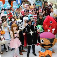 Japanese toy company Tomy president Harold Meij (dressed as a musketeer) and employees clad in costumes pose as they gather for the company\'s Halloween Day event at the Tomy headquarters. The Japanese toymaker\'s employees were allowed to wear their favorite costumes in observance of the holiday. | AFP-JIJI