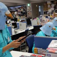 Employees dressed as Twitter birds work at their desks during the company\'s Halloween Day event. | AFP-JIJI