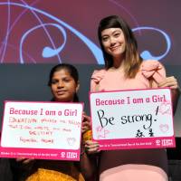 Priyanka Naik, an 18-year-old student from India, and model Hikari Mori hold messages during a \"Because I am a Girl\" campaign event for \"International Day of the Girl Child\'\' on Oct. 11, at United Nations University in Tokyo. The event was sponsored by Plan Japan. | YOSHIAKI MIURA