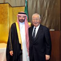Saudi Arabian Ambassador Ahmad Younos S. Al Barrak (left) welcomes Japan-Saudi Arabia Society Chairman Hiromasa Yonekura, during a reception to celebrate the country\'s 85th National Day at the Palace Hotel Tokyo on Sept. 29. | YOSHIAKI MIURA