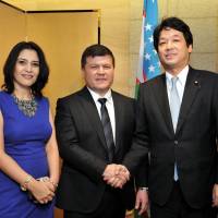 Uzbekistan Ambassador Farrukh Tursunov (center), and his wife, Madina welcome Parliamentary Vice-Minister for Foreign Affairs Kentaro Sonoura (right), during a reception to celebrate the country\'s independence day at the Hotel Okura, Tokyo on Sept. 25. | YOSHIAKI MIURA