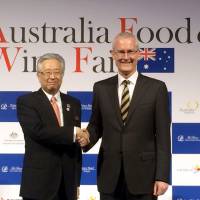 Australian Ambassador Bruce Miller (right) and Hisaaki Takei, Senior Corporate Executive Officer of Prince Hotels, Inc., shake hands at the opening ceremony of the Australia Food &amp; Wine Fair at the Prince Park Tower Tokyo on Sept. 28. The fair will be held at 43 restaurants in seven Prince Hotels in the Tokyo Metropolitan area through November. | HIROKO INOUE