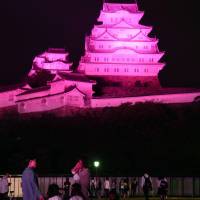 World Heritage-listed Himeji Castle in Hyogo Prefecture was lit up in pink Thursday night to promote the launch of a monthlong campaign through October urging women to be checked for breast cancer. | KYODO