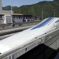 An L0 series magnetic levitation (maglev) train, developed by Central Japan Railway Co. (JR Central), sits on a track ahead of a trial run at the Yamanashi Maglev Test Track site in Tsuru, Yamanashi Prefecture, on June 4. | BLOOMBERG