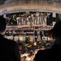 People gather at a makeshift memorial for the victims of Paris\' attacks at the Place de la Republique in Paris, on Sunday. | AFP-JIJI