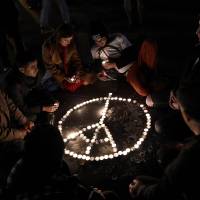 People gather in tribute of the victims of Paris\' attacks at the Place de la Republique in Paris, on Sunday. | AFP-JIJI