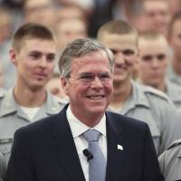 Republican U.S. presidential candidate Jeb Bush poses with cadets after speaking about his plans for the U.S. military at The Citadel, The Military College of South Carolina in Charleston, South Carolina, Wednesday. Bush called for an increased U.S. troop presence on the ground in Iraq as part of a global coalition to take on Islamic State militants, shifting to a more hawkish stance in response to the Paris attacks. | REUTERS