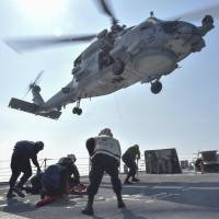 U.S. Navy Sailors participate in a training exercise on the deck of the USS Lassen guided-missile destroyer in the South China Sea on Wednesday. | REUTERS