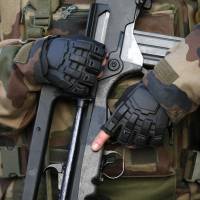 A soldier carrying a Famas assault rifle patrols in front of the Louvre museum in Paris on Friday. | REUTERS