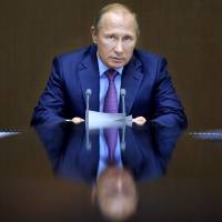 Russian President Vladimir Putin chairs a meeting with defense officials at the Bocharov Ruchei residence in the Black Sea resort of Sochi, Russia, on Nov. 10. | AP