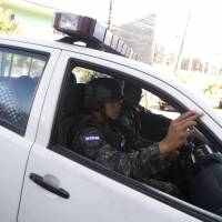 Soldiers escort three of five Syrians inside a military vehicle as they are taken to court in TegucigalpaTuesday. The group of five Syrians paid smugglers $10,000 each to travel through multiple countries before being detained for carrying false Greek documents in Honduras, their epic journey exposing a little-known southern smuggling route for Syrians fleeing war in their homeland. | REUTERS