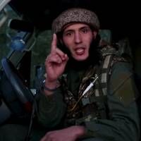 A man identified in the subtitiles as Al Ghareeb the Algerian speaks at an undisclosed location in this image taken from undated video footage released by the Islamic State, which warned in the new video Monday that countries taking part in airstrikes against Syria would suffer the same fate as France, and threatened to attack in Washington. The video, which appeared on a site used by Islamic State to post its messages, begins with news footage of the aftermath of Friday\'s Paris shootings in which at least 129 people were killed. | REUTERS / SOCIAL MEDIA WEBSITE VIA REUTERS