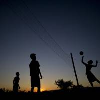 Youths play volleyball in Naypyitaw on Saturday, a day after Aung San Suu Kyi\'s National League for Democracy secured a parliamentary majority and a mandate to form a government, ousting Myanmar\'s military from power. | AFP-JIJI