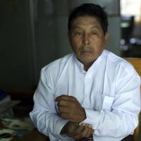 Muslim candidate Khin Maung Thein speaks to a reporter in Mandalay on Oct. 5. The city is a Buddhist religious center crowded with temples, monasteries and monks. Khin, the only Mandalay Muslim to run in the Nov. 8 election, runs his campaign from a cluttered home that doubles as the family printing business. | REUTERS