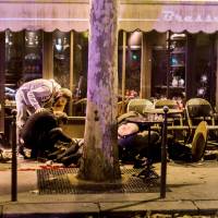People lie outside the Cafe Bonne Biere in Paris following coordinated attacks that left 130 people dead on Nov. 13. | AFP-JIJI