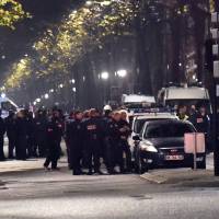 Police cordon off the area close to where armed men have taken hostages in the northern French town of Roubaix on Tuesday. Roubaix\'s mayor office said the suspect or suspects \"carried out a robbery.\" | AFP-JIJI