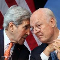 U.S. Secretary of State John Kerry speaks with U.N. Special Envoy for Syria Staffan de Mistura during a news conference in Vienna on Saturday. | AP