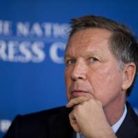 Republican presidential candidate Ohio Gov. John Kasich looks to the audience as he is introduced to speak at the National Press Club in Washington, Nov. 17. | AP