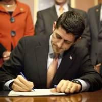 House Speaker Paul Ryan of Wis. signs the National Defense Authorization Act (S. 1356) Tuesday on Capitol Hill in Washington. | AP