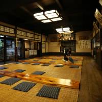 A worker prepares the dining room of Komakata Dozeu for another day of business. | RIE ISHII