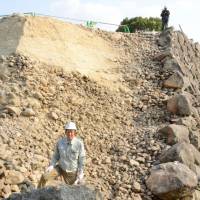 A stone wall of Koriyama Castle in Yamatokoriyama, Nara Prefecture, is being dismantled in October for repair work. | KYODO