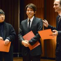 Shoichi Yabuta (center) is awarded first prize for composition at the 2015 Geneva International Music Competition in Geneva on Sunday. | KYODO