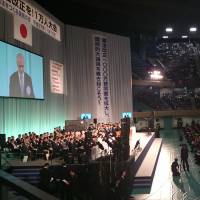 Nippon Budokan Hall in Chiyoda Ward, Tokyo, is packed Tuesday afternoon with people calling for revisions to the pacifist Constitution. | REIJI YOSHIDA