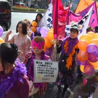 Victims of domestic violence and sexual abuse take part in a rally with their supporters along Omotesando Dori in Tokyo on Sunday. | SATOKO KAWASAKI