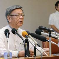Okinawa Gov. Takeshi Onaga faces the media at a news conference Monday in Naha after the prefectural government filed a complaint against the central government\'s decision to overrule its attempt to block landfill work for the Futenma base relocation. | KYODO