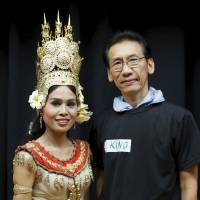 Ky Tu Duong (right), a former Vietnamese refugee who now goes by his Japanese name of Hitoshi Kino, and Cheth Chan Chrisna, a former Cambodian refugee who now goes by her married name of Chrisna Ito, pose during the Asia Sports Festa in Yokohama on Oct. 25. | REUTERS