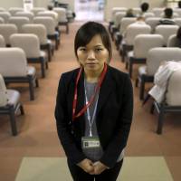 Dang Nguyen Thuc Vien, a 32-year-old daughter of refugees from the former South Vietnam, is seen Wednesday at a hospital in Kanagawa Prefecture, where she works as an interpreter. | REUTERS