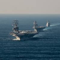 U.S. aircraft carrier USS Ronald Reagan steams ahead of Japan Maritime Self-Defense Force destroyers JS Izumo and JS Teruzuki in waters south of Japan during a fleet review on Oct. 18. | USS RONALD REAGAN (CVN 76)