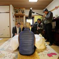 Shoichi Yukawa (center), father of Haruna Yukawa, one of two Japanese hostages executed by the Islamic State group, speaks to reporters at his residence in Chiba Prefecture on Jan. 25. | AFP-JIJI